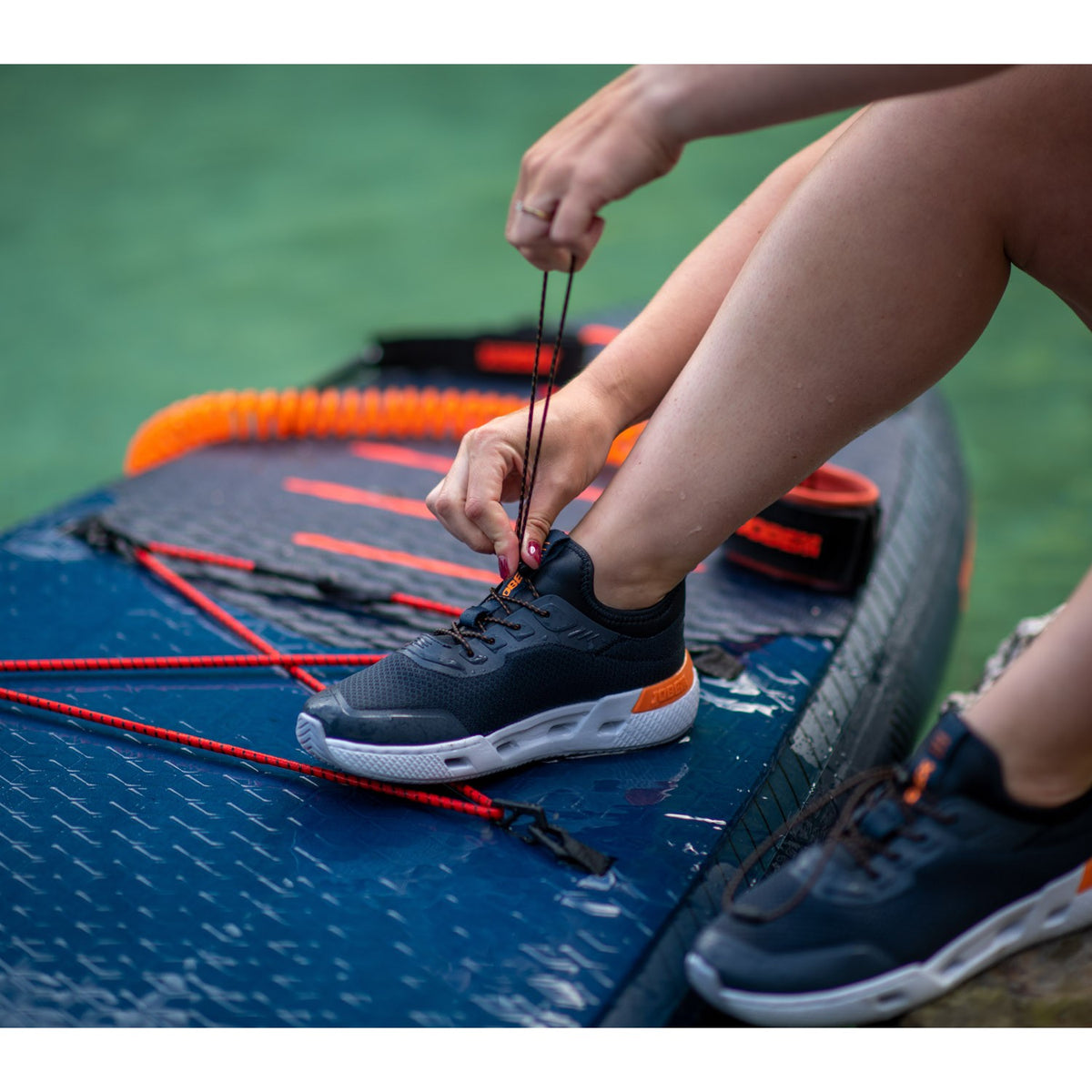 Schnellschnürung des Jobe Discover Sneakers auf dem SUP-Board